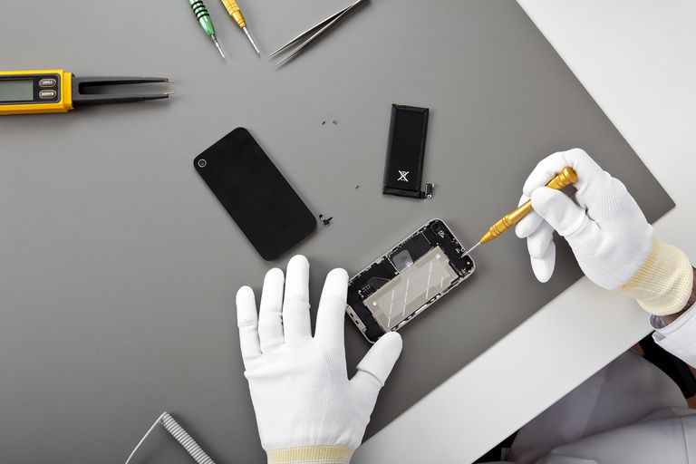 FLM 380 Wireless technician repairing an iPhone at the Brooklyn workbench